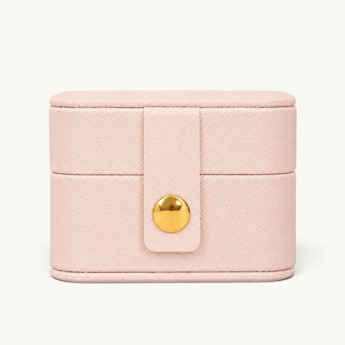 Boîte à bagues de voyage rose fermée, extérieur effet cuir grainé et fermoir à pression doré