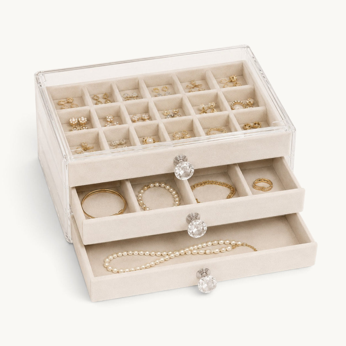 Organisateur de bijoux à tiroirs beige, plateau à compartiments garni de boucles d'oreilles