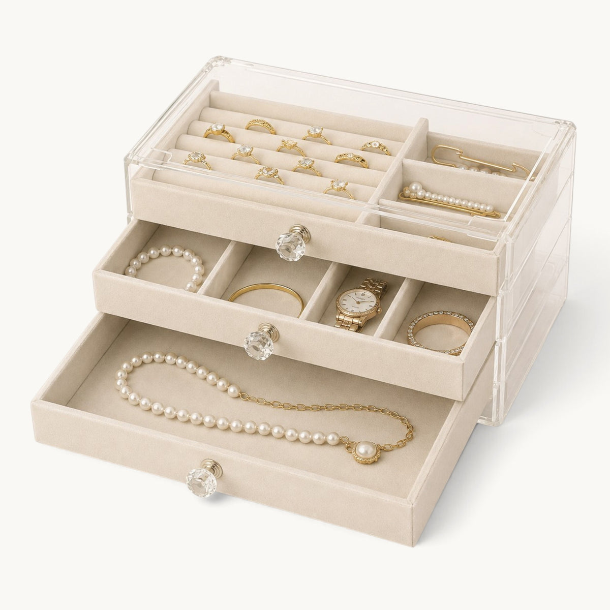 Organisateur de bijoux à tiroirs beige, les trois tiroirs ouverts et garnis de velours