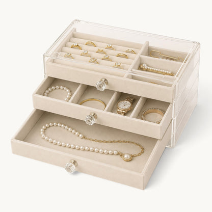 Organisateur de bijoux à tiroirs beige, les trois tiroirs ouverts et garnis de velours