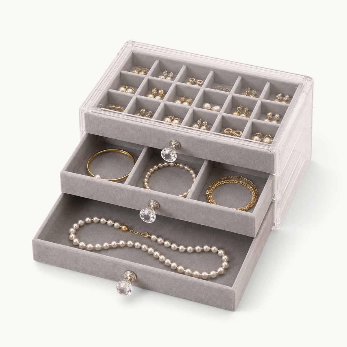 Organisateur de bijoux à tiroirs gris, plateau à compartiments garni de boucles d'oreilles